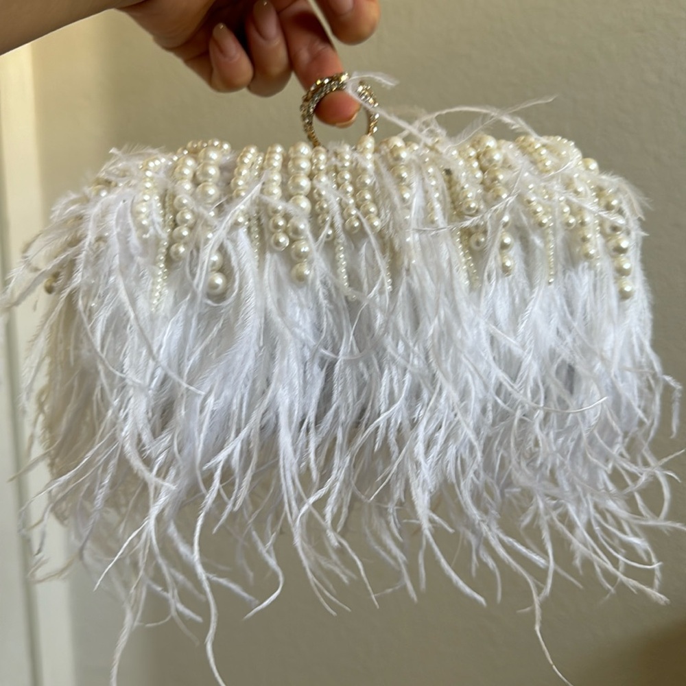 Brand new white feather and pearl clutch with two straps.